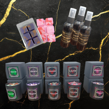 Collection of wax melts, containers, and bottles on a dark surface with gold accents